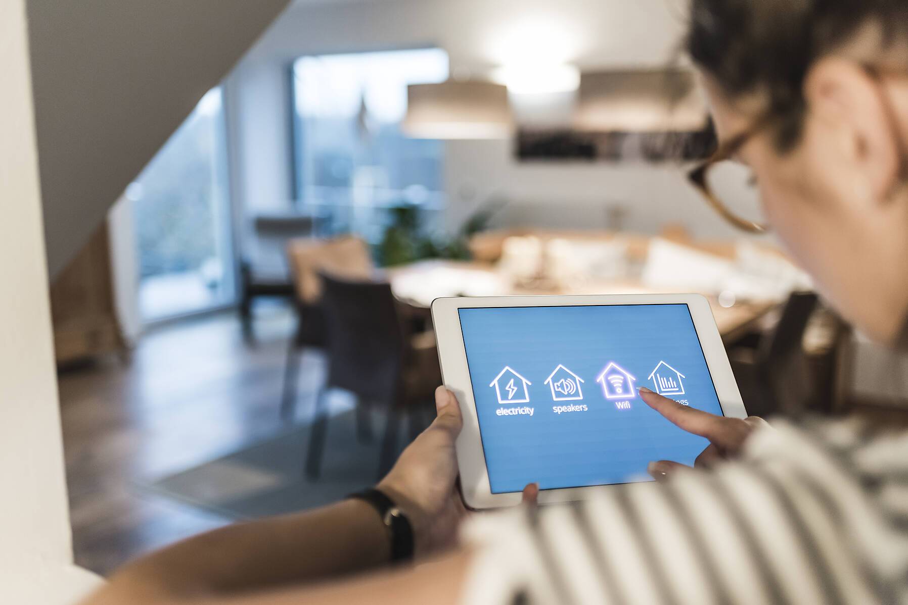 royalty-free stock image, Woman using tablet with smart home control functions at home