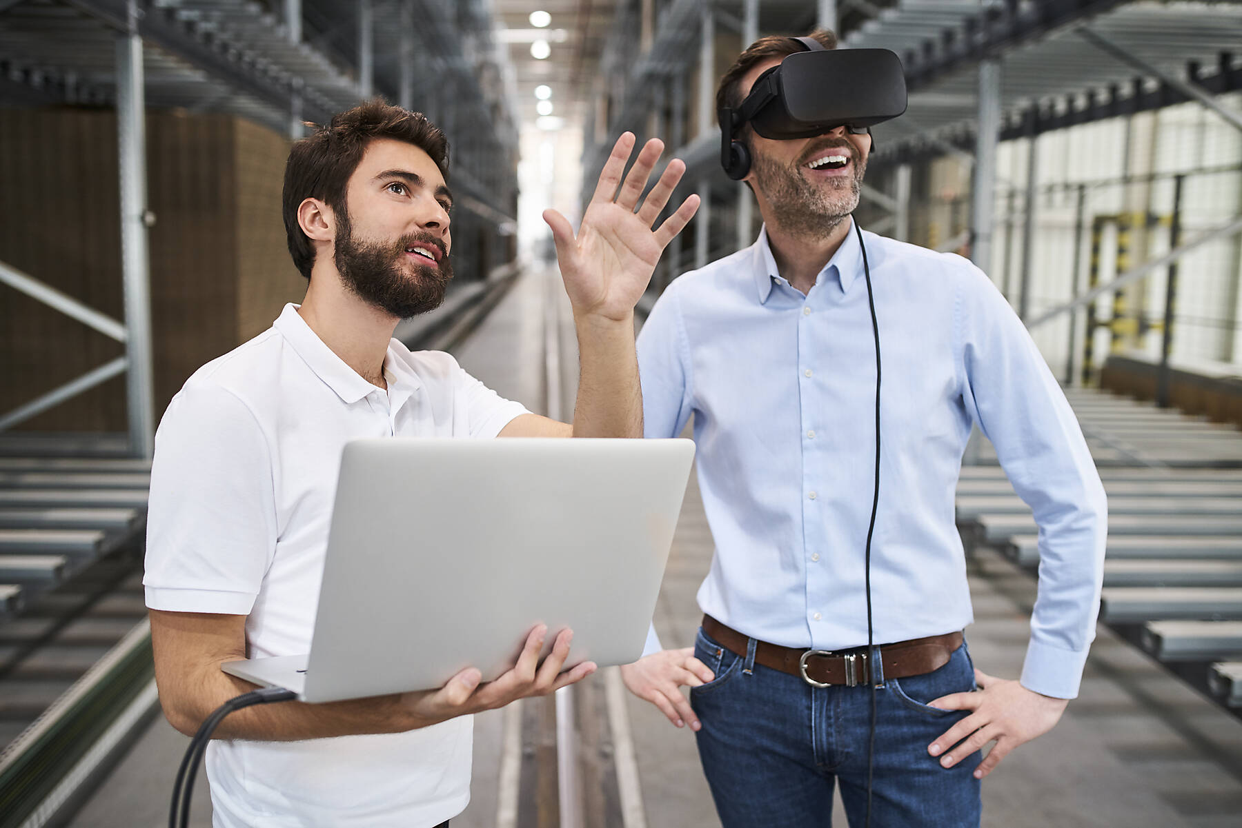 stock image, royalty-free, Man with laptop and businessman wearing VR glasses in factory