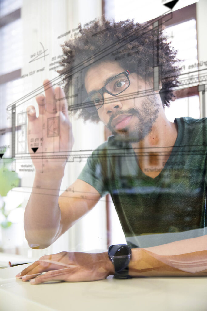 Young man using transparent touchscreen display
