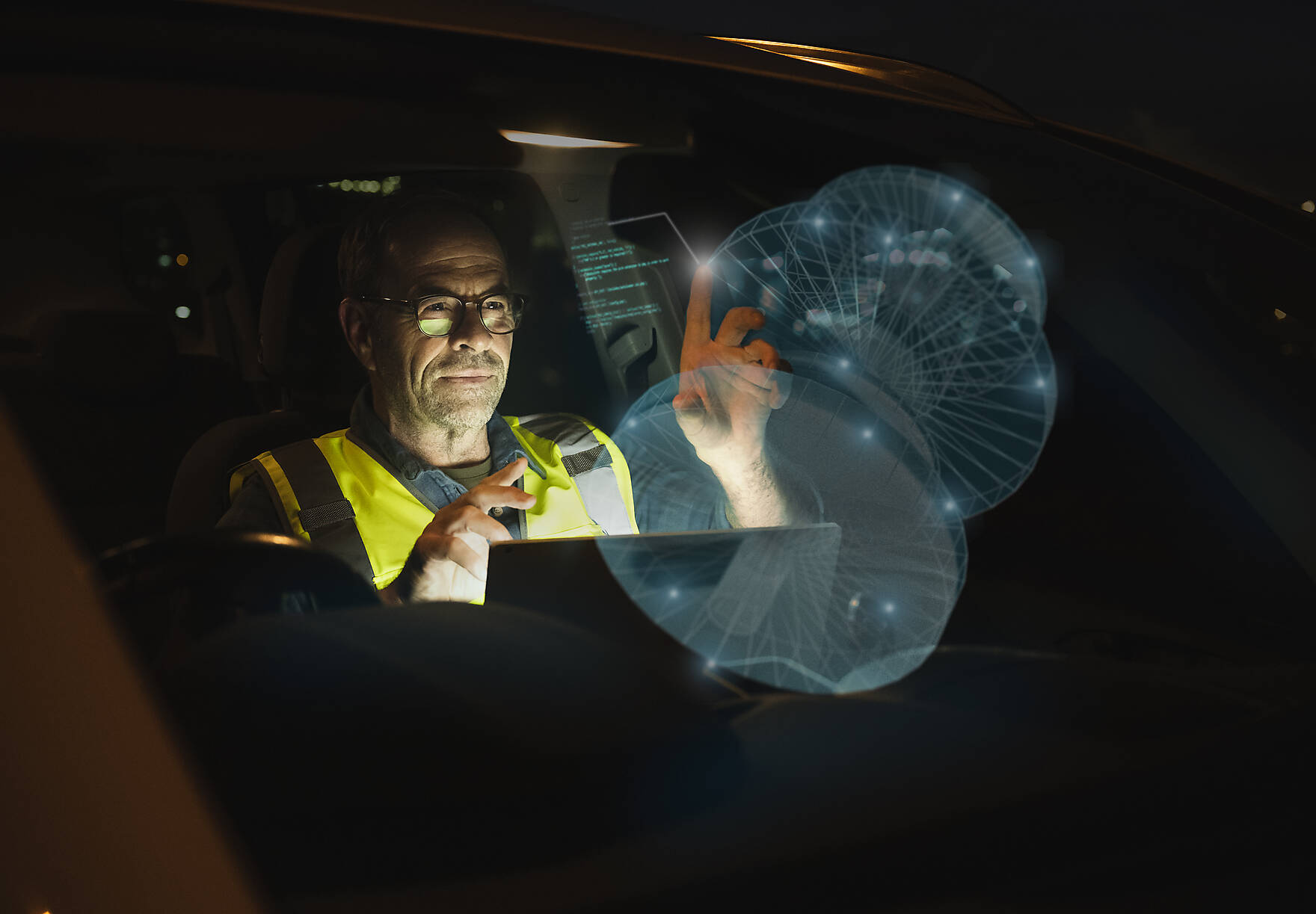 Stock image, royalty-free, Engineer working on futuristic graph in car