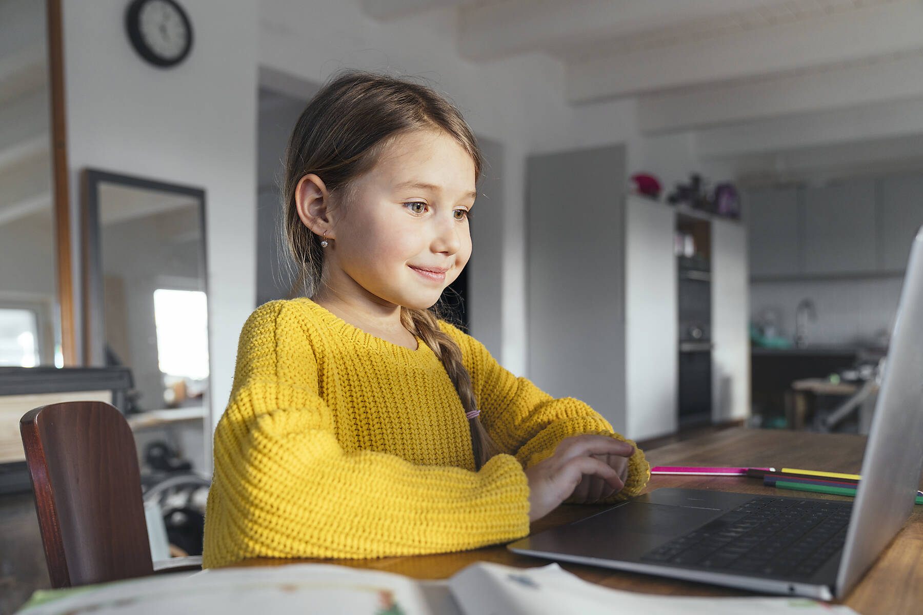 stock image, royalty-free, Smiling cute girl using laptop on table at home