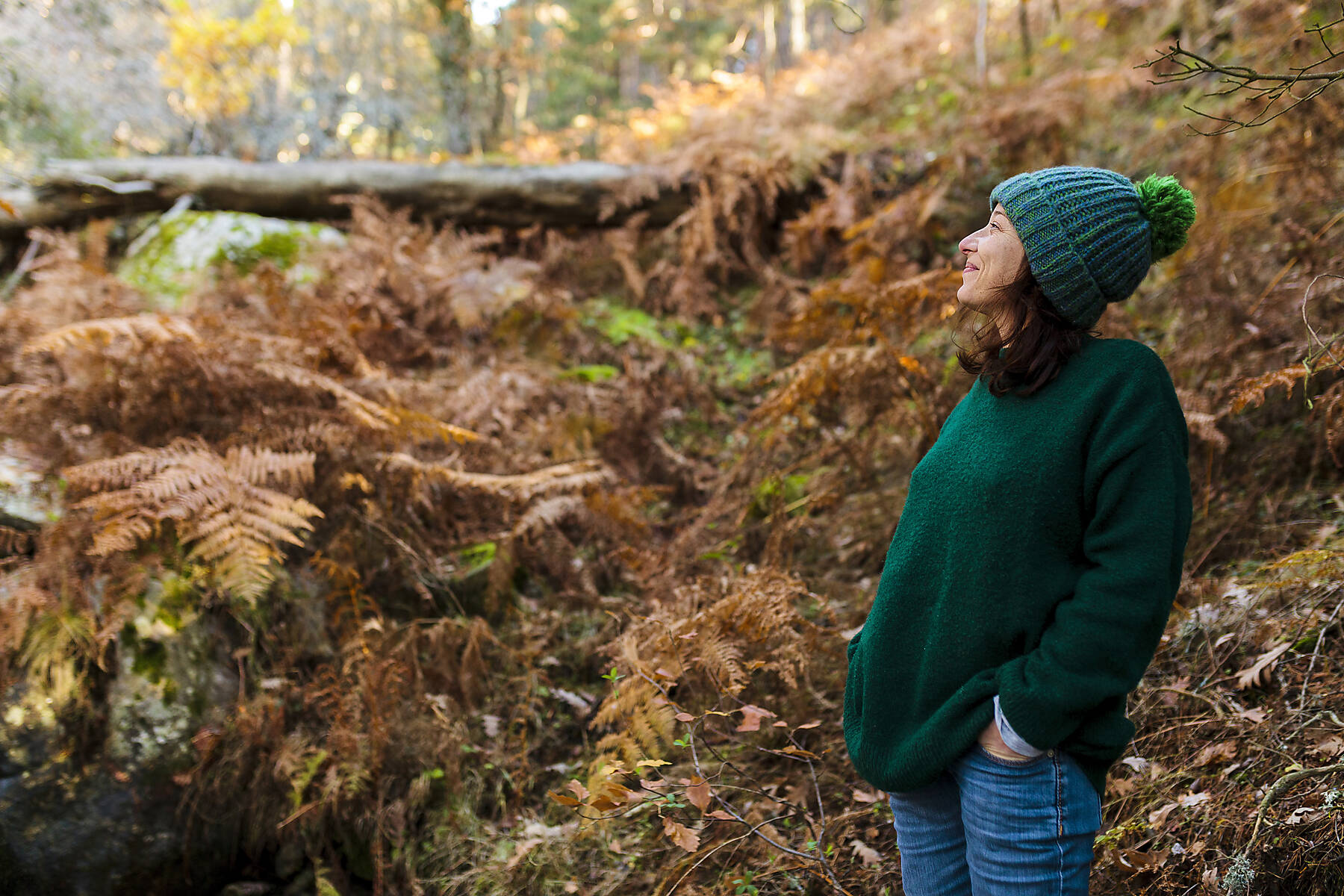 stock image, royalt-free, Smiling woman with hand in pocket looking away at forest