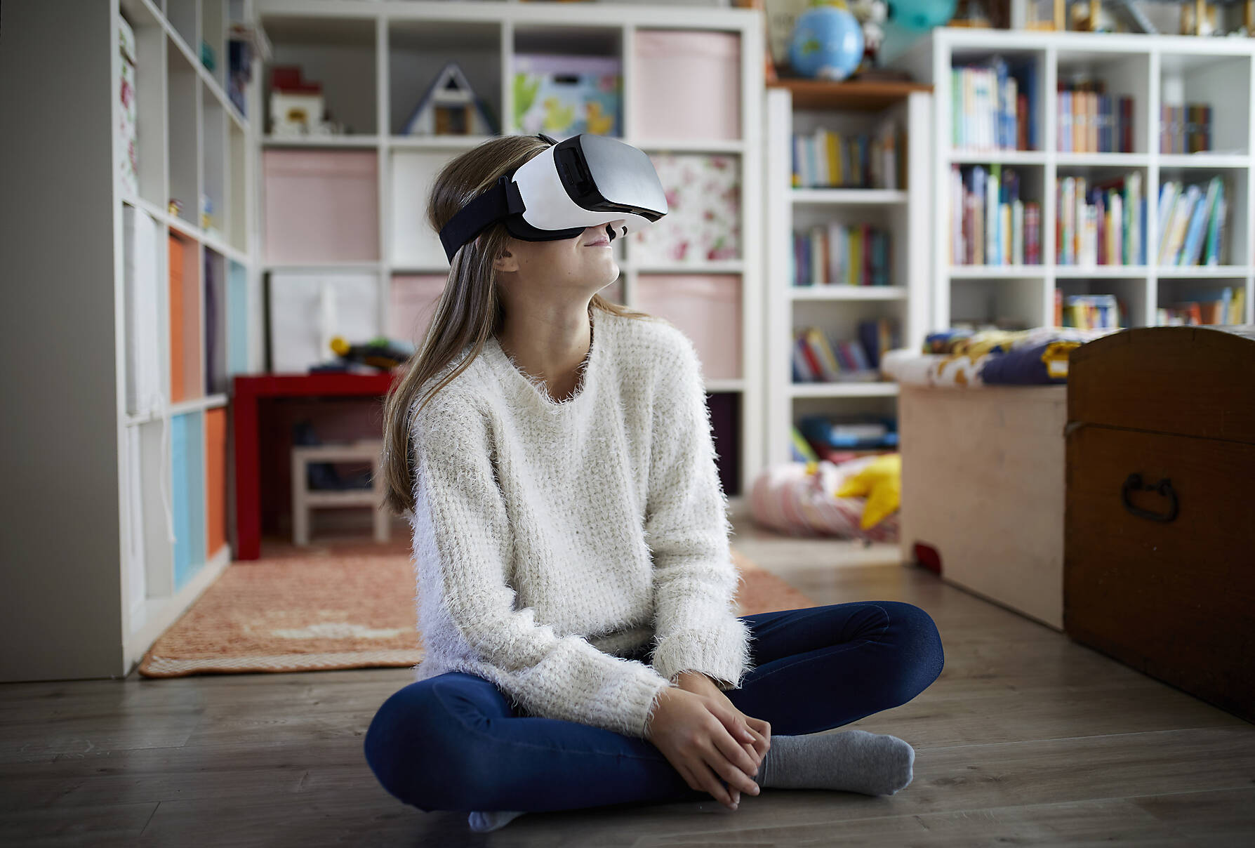 stock image, royalty-free, Girl sitting in her room, using Virtual Reality goggles