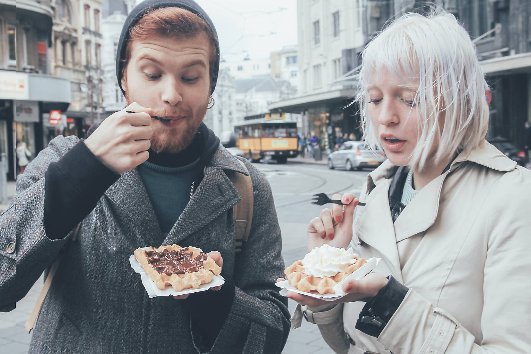 Stock image, royalty-free, Belgium, Antwerp, young couple eating Belgian waffles on the street