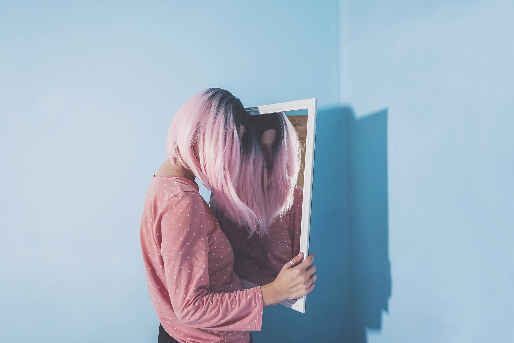 Stock image, royalty-free, Woman leaning on mirror at home