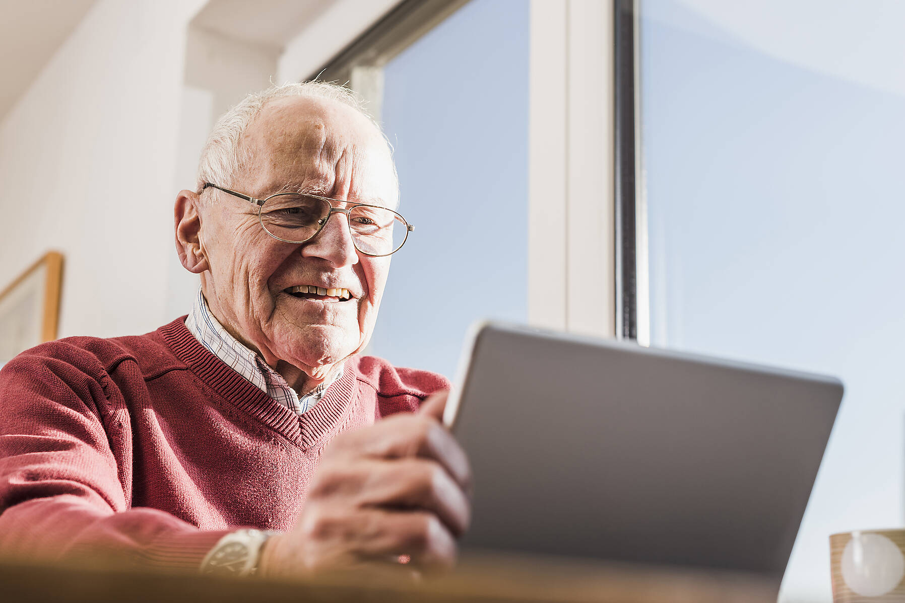 stock image, royalty-free, Senior man sitting at home, using laptop