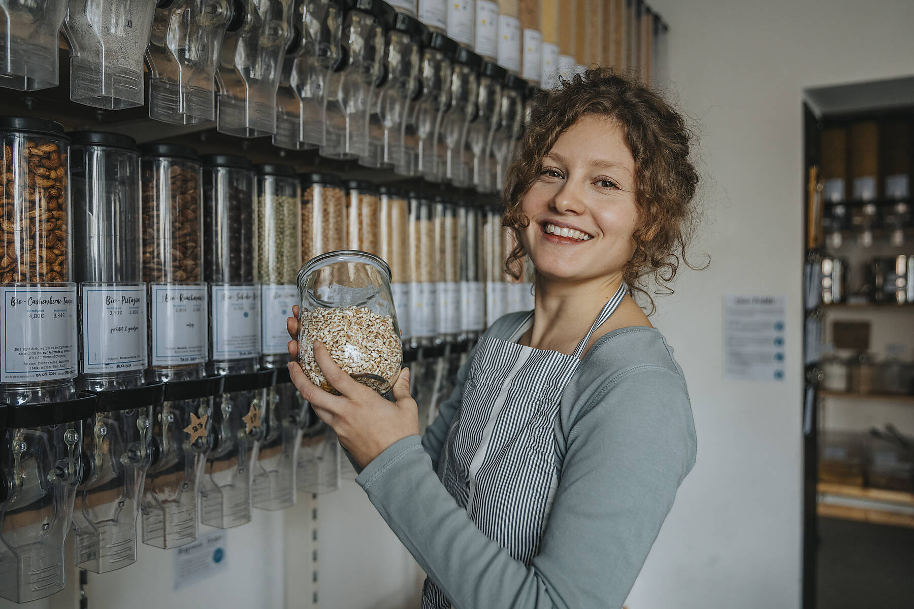 stock image, royalty-free, Store clerk in zero waste shop, Cologne, NRW, Germany