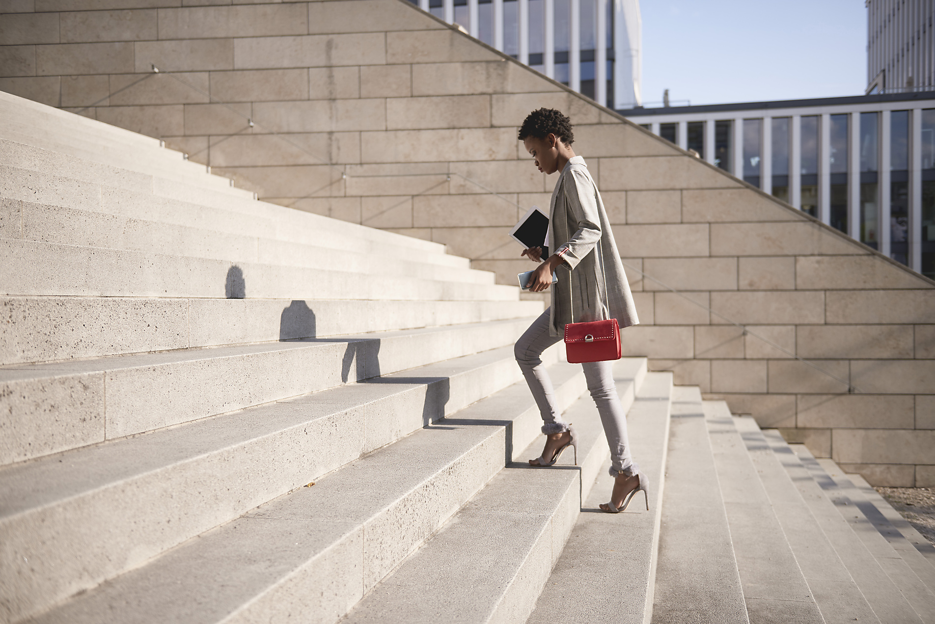 Stock image, royalty-free, Businesswoman walking up stairs
