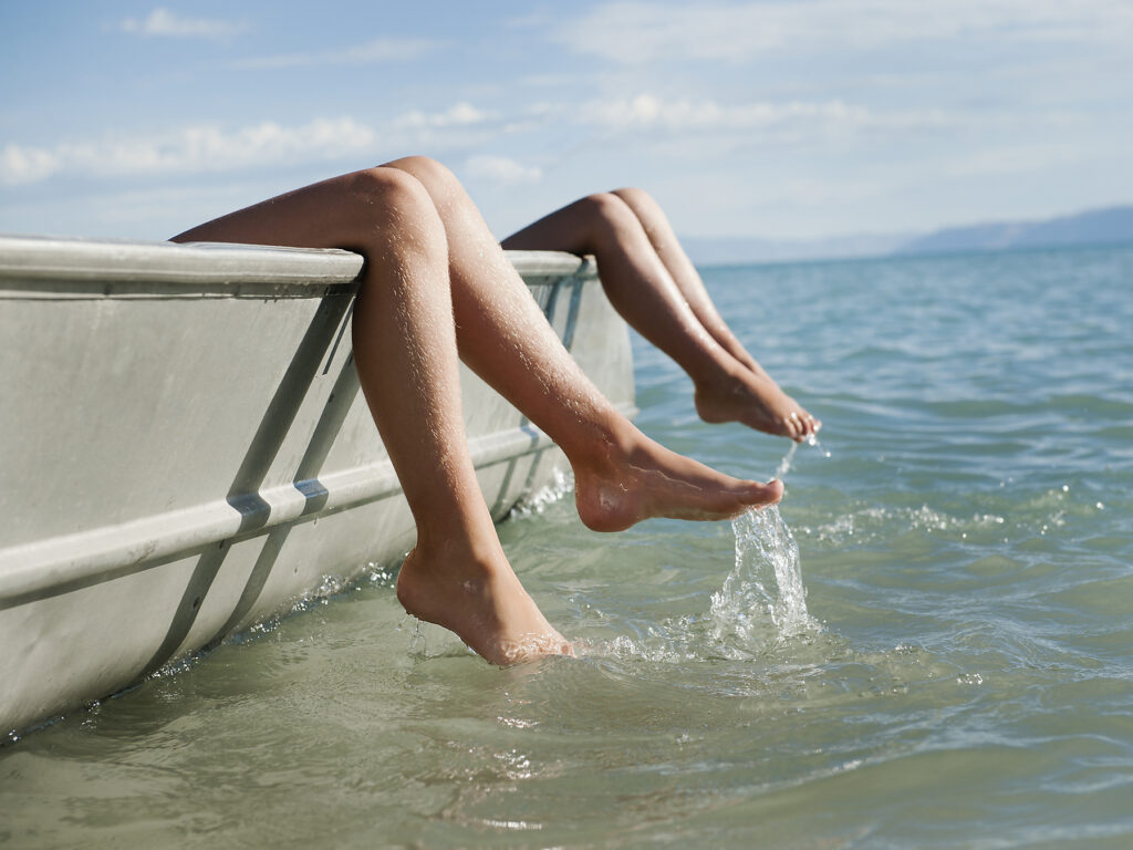 Stock image, royalty-free, Girls resting on boat, hot summer day, water, lake, refreshing