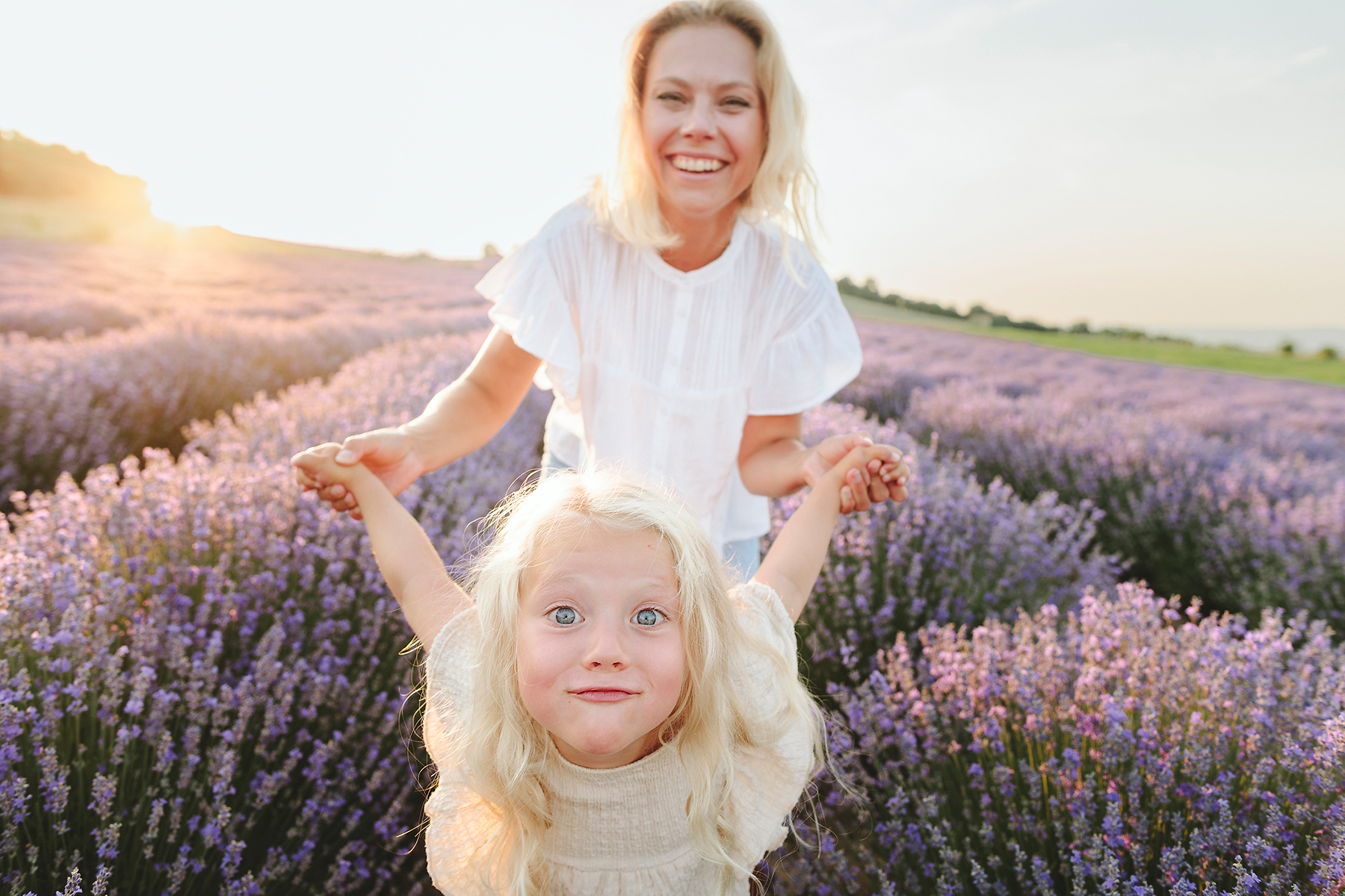 stock photo, royalty-free, Happy mother playing with daughter in lavender field at sunset