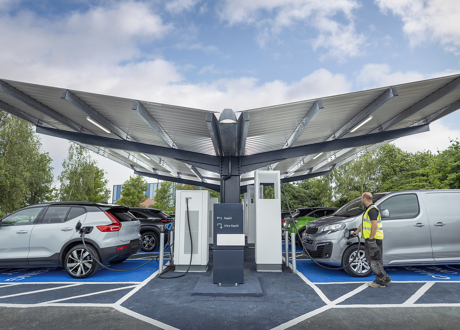 stock image, royalty-free, Electric cars at charging station, Energy transition, climate change, sustainable, zero emission, climate positive,