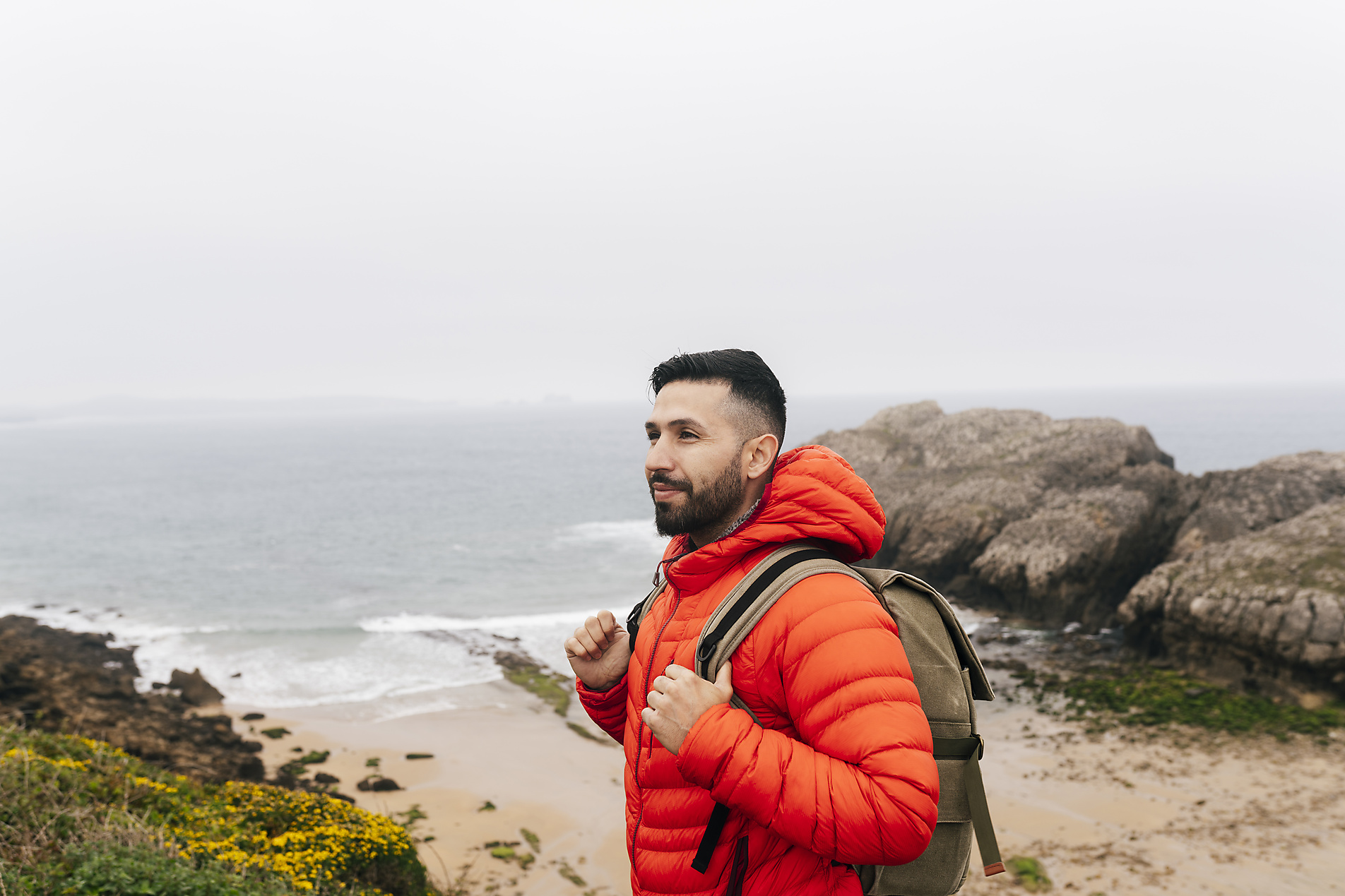 stock image, royalty-free, jose carlos ichiro wearing backpack standing in front of sea