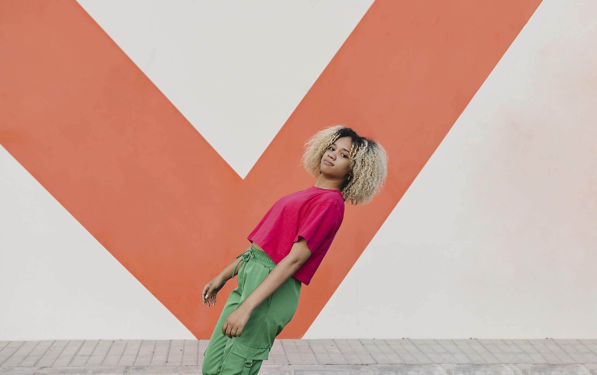 Stock image, royalty-free, Young woman bending backward by wall