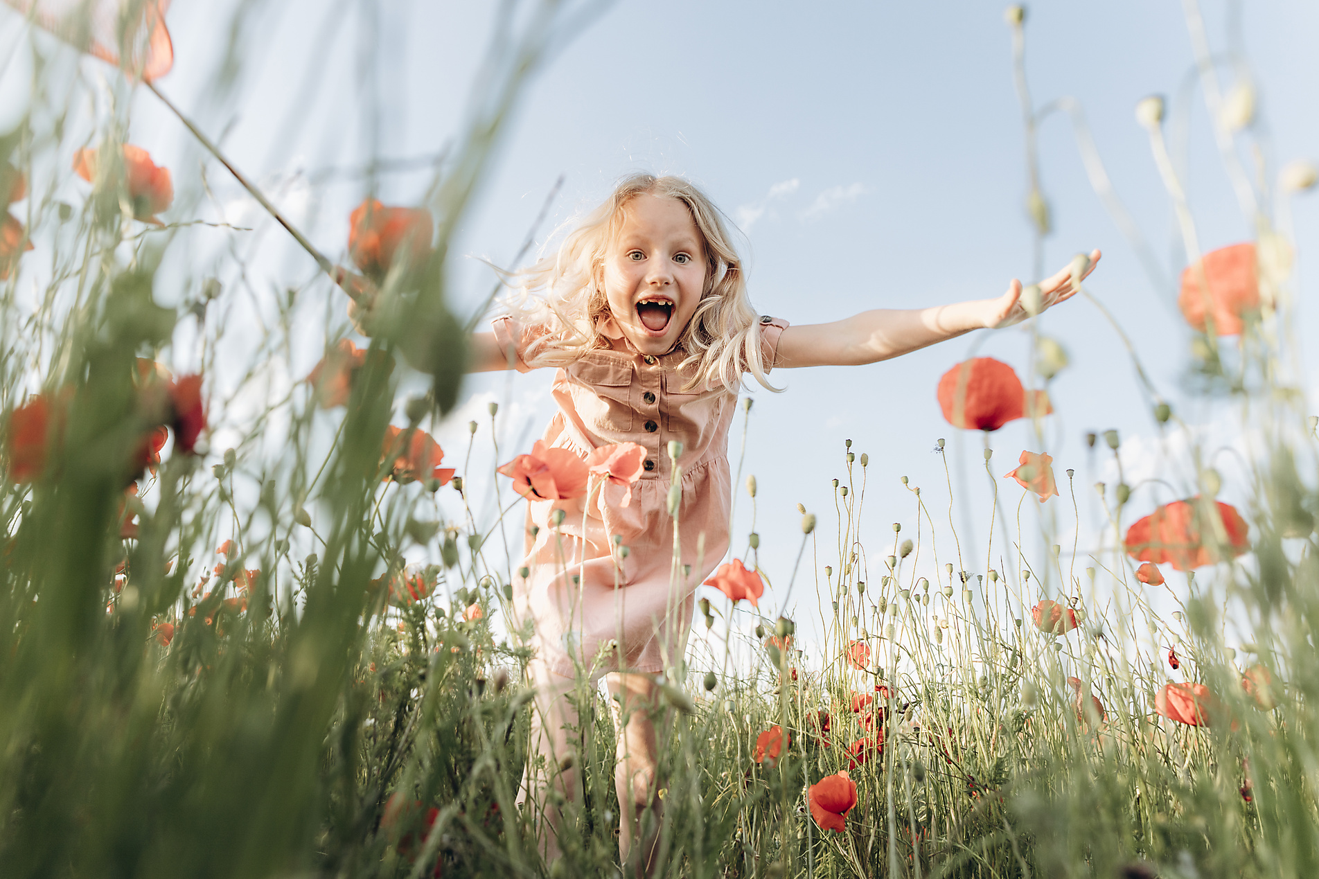 stock photo, royalty free, Playful girl jumping in poppy field