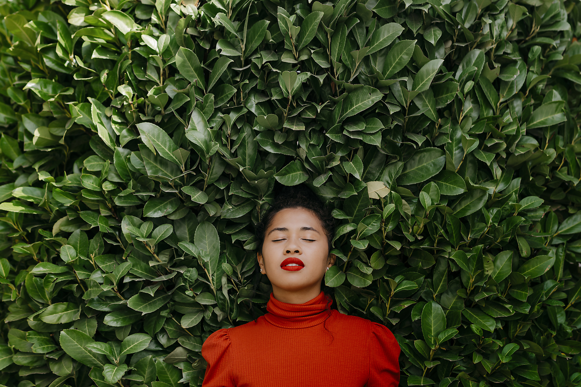 stock image, royalty-free, Woman with eyes closed in front of green plants, homepage headers