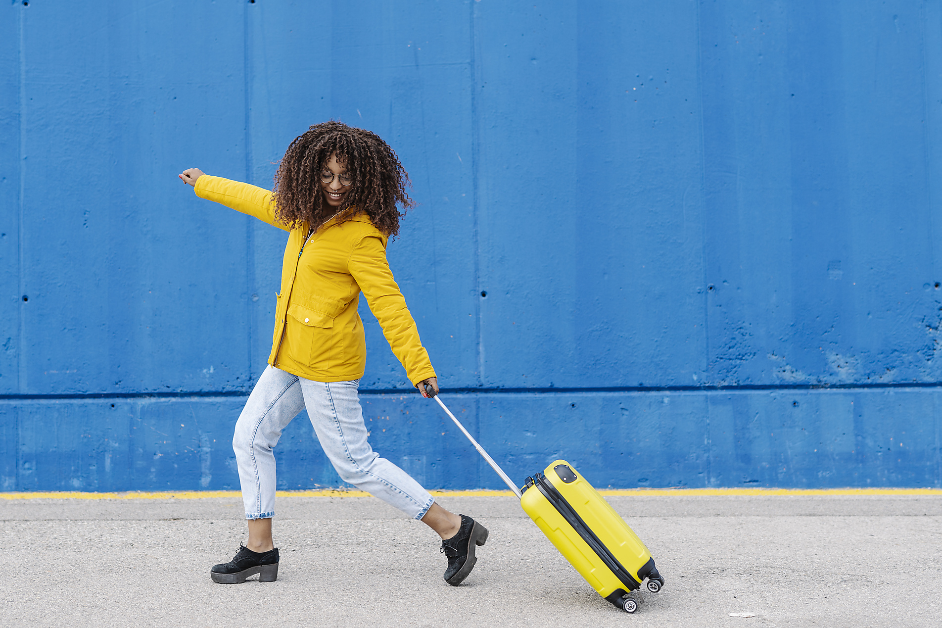 Stock image, royalty-free, Carefree woman running with luggage on footpath, Joan, Corominas