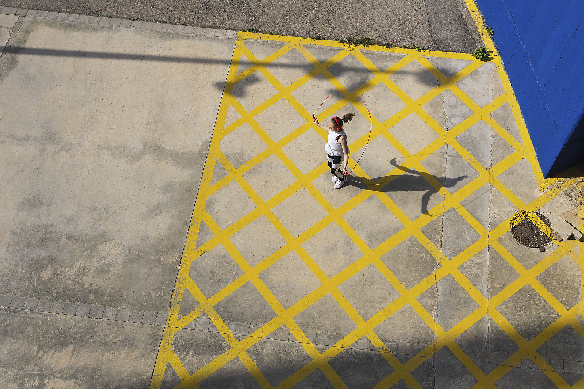 stock image, royalty-free, Female athlete jumping rope on road during sunny day, pau novell
