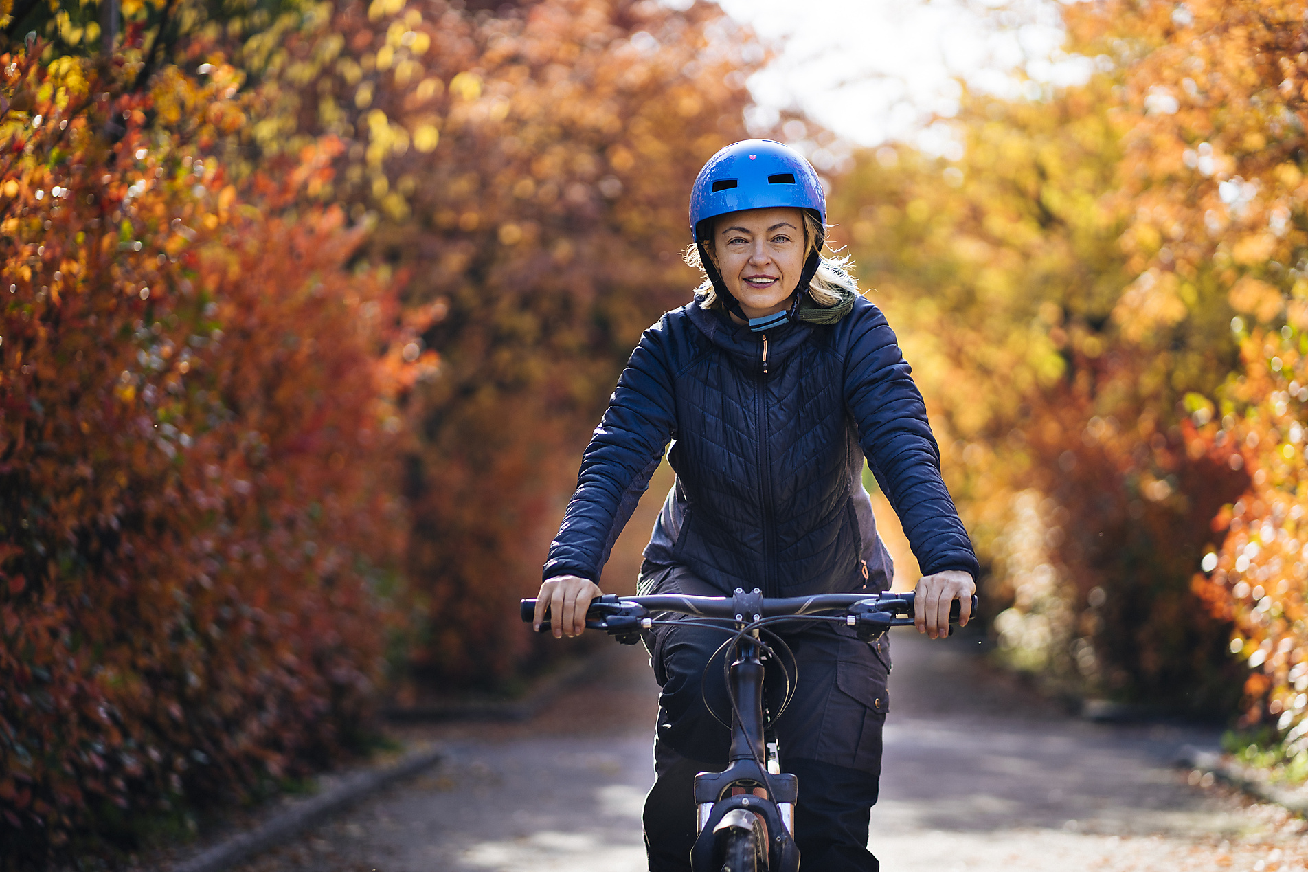 royalty-free, stock image, Finland Kupio Outdoors Fall Woman cycling, Autumn, blue helmet, Petra Silie 