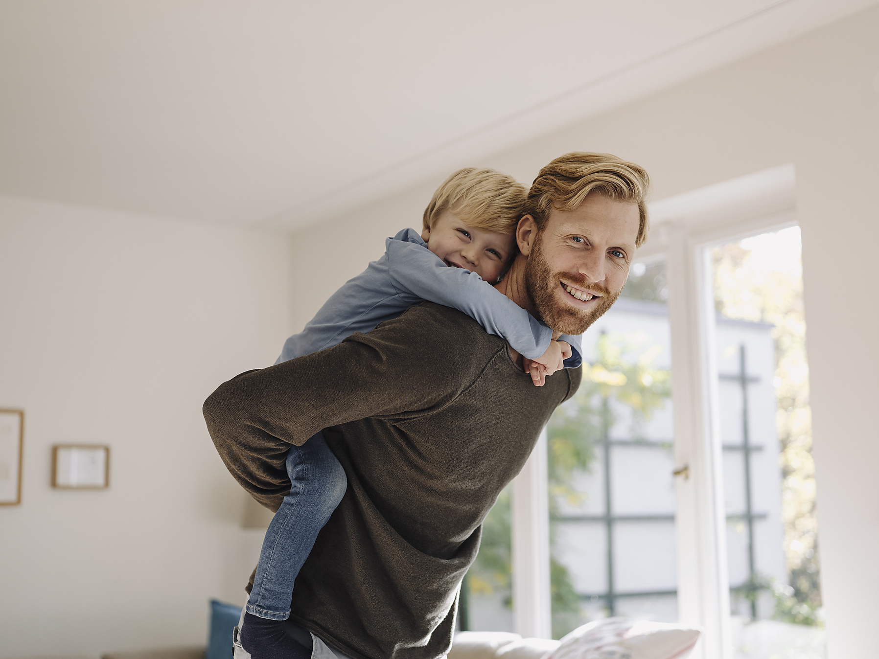 stock image, royalty-free, Portrait of happy father carrying son piggyback at home, westend61, kniel synnatzschke