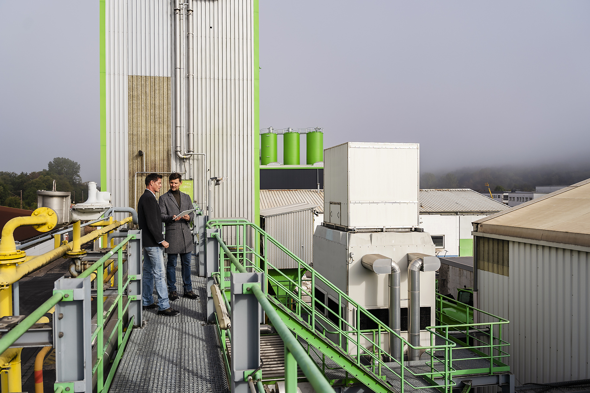 stock image, royalty-free, Mature businessman with colleague discussing together at recycling plant, Westend61, Pyrum Innovations, Recycling, Sustainability, eco-friendly, Industry, Daniel Ingold,