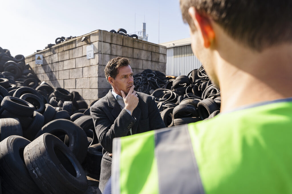 stock image, royalty-free, westend61, daniel ingold, pyrum innovations, sustainability, recycling, Thoughtful businessman with colleague standing in front of tires