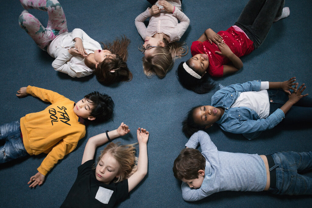 stock image, royalty-free, Directly above shot of school children lying on floor in classroom, westend61, maskot images, education, future, school