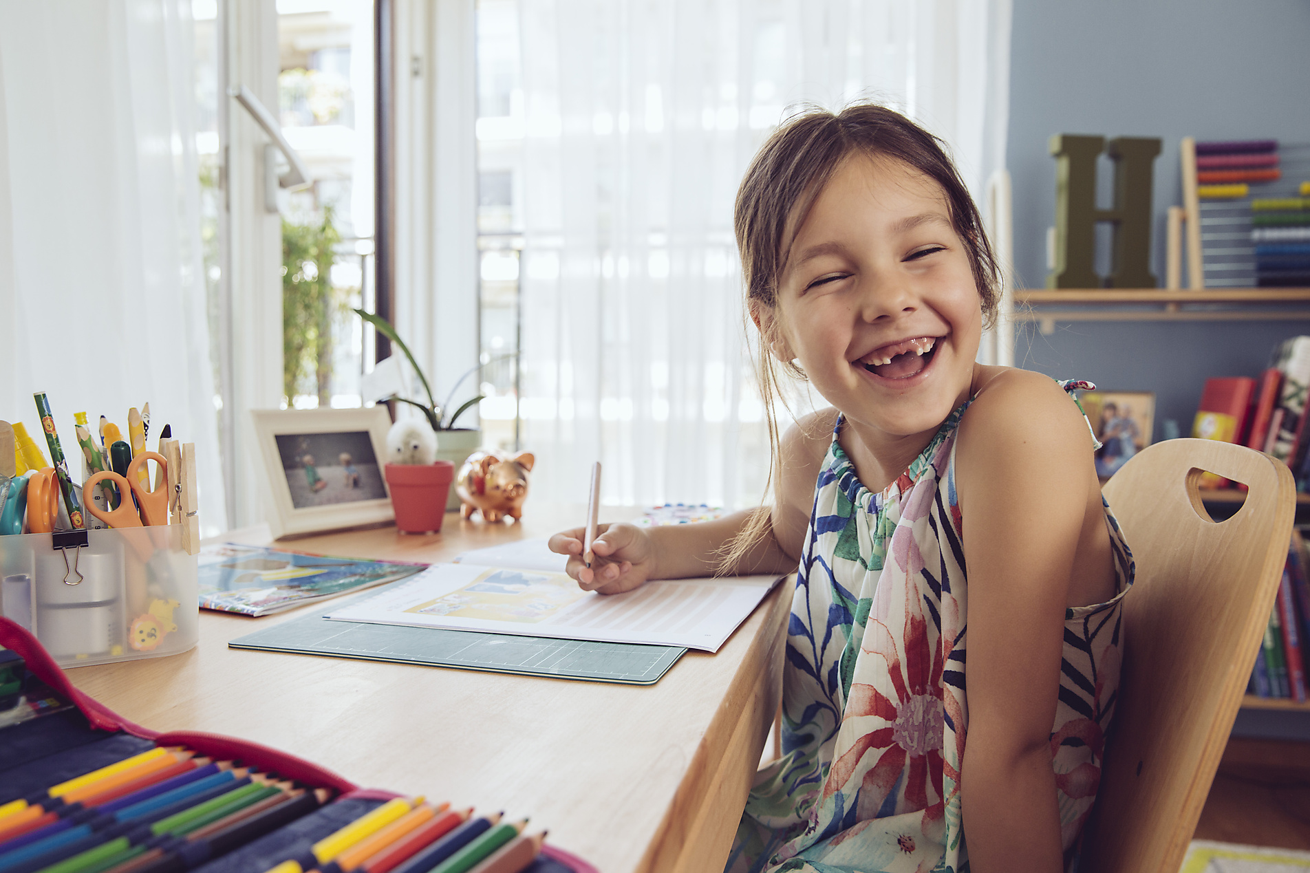 stock image, royalty-free, westend61, Mareen Fischinger, Happy girl doing her schoolwork at home, Education, future