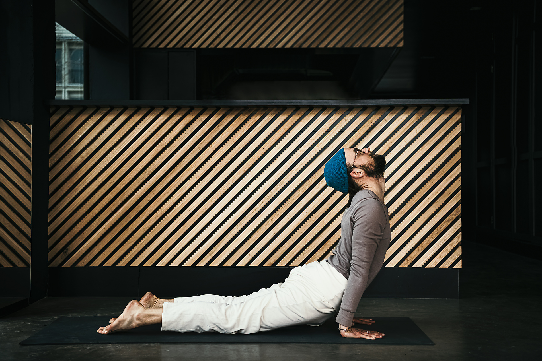 Bhujangasana, Male fitness instructor practicing cobra pose in exercise room, stock image, royalty-free, westend61