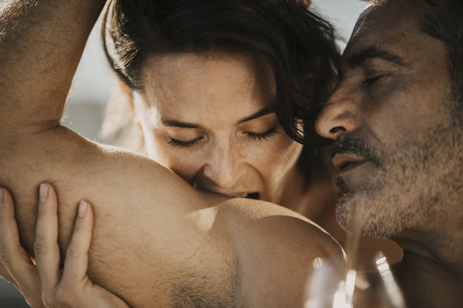 Romantic woman biting on shoulder of boyfriend, stock image, royalty-free, Malte Jäger
