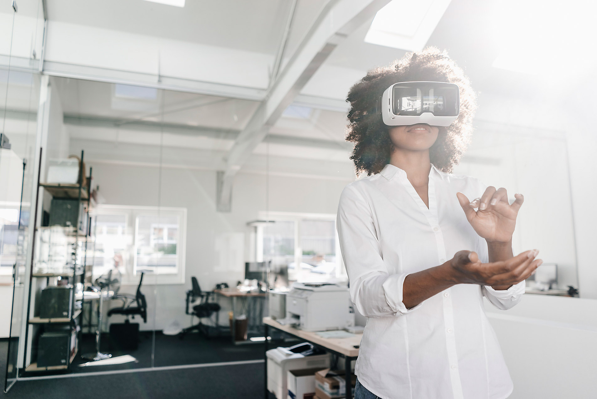 Woman wearing VR glasses in office, stock image, royalty-free, metaverse, westend61