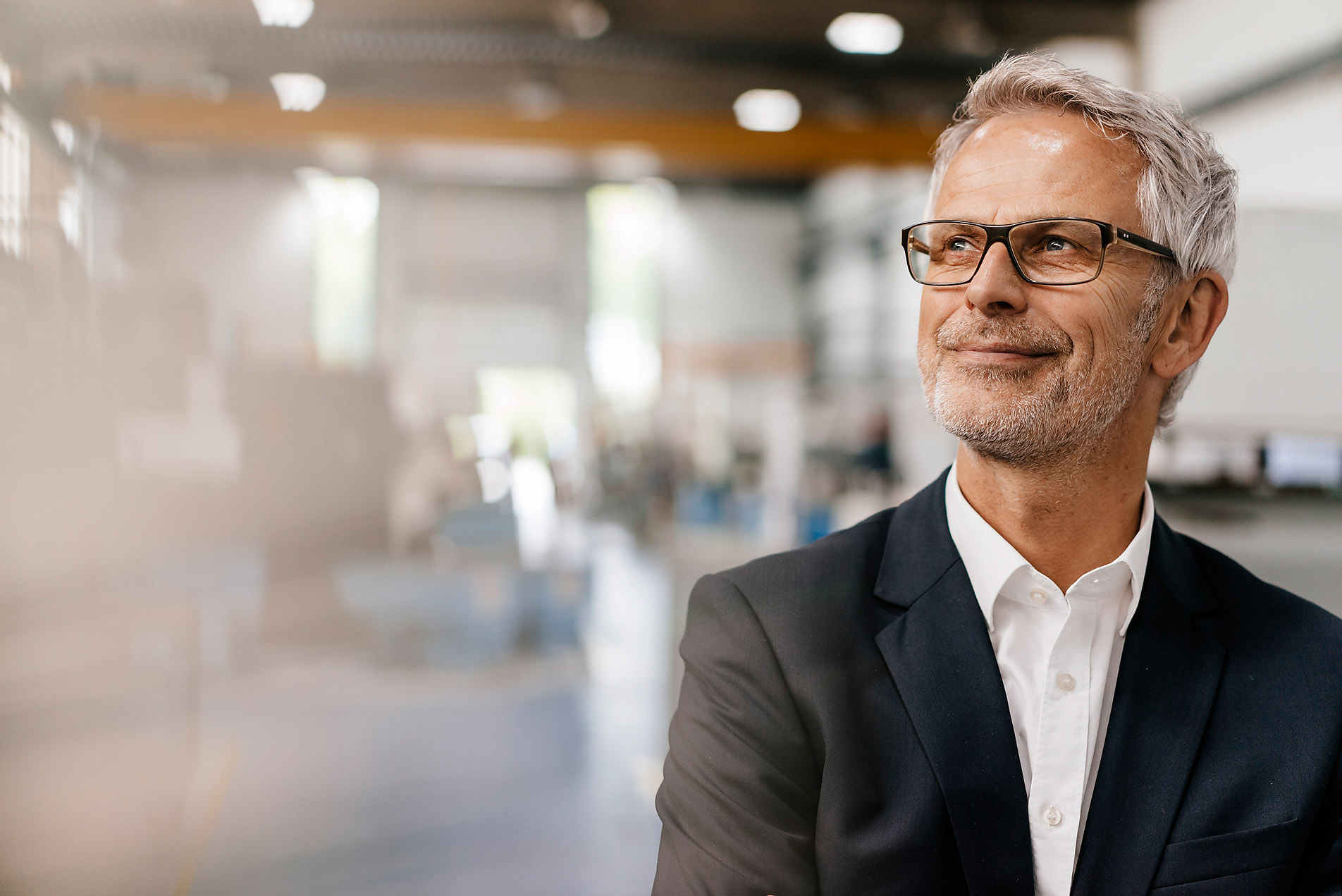 Portrait of a successful entrepreneur in his company, blurred background, businessman in a suit, gray hair, westend61, stock photo, royalty-free, imagination, future, vision