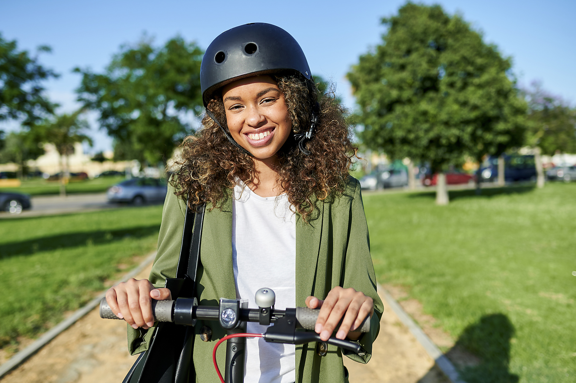 Stock Image, Royalty Free, Happy young woman standing with electric push scooter during sunny day