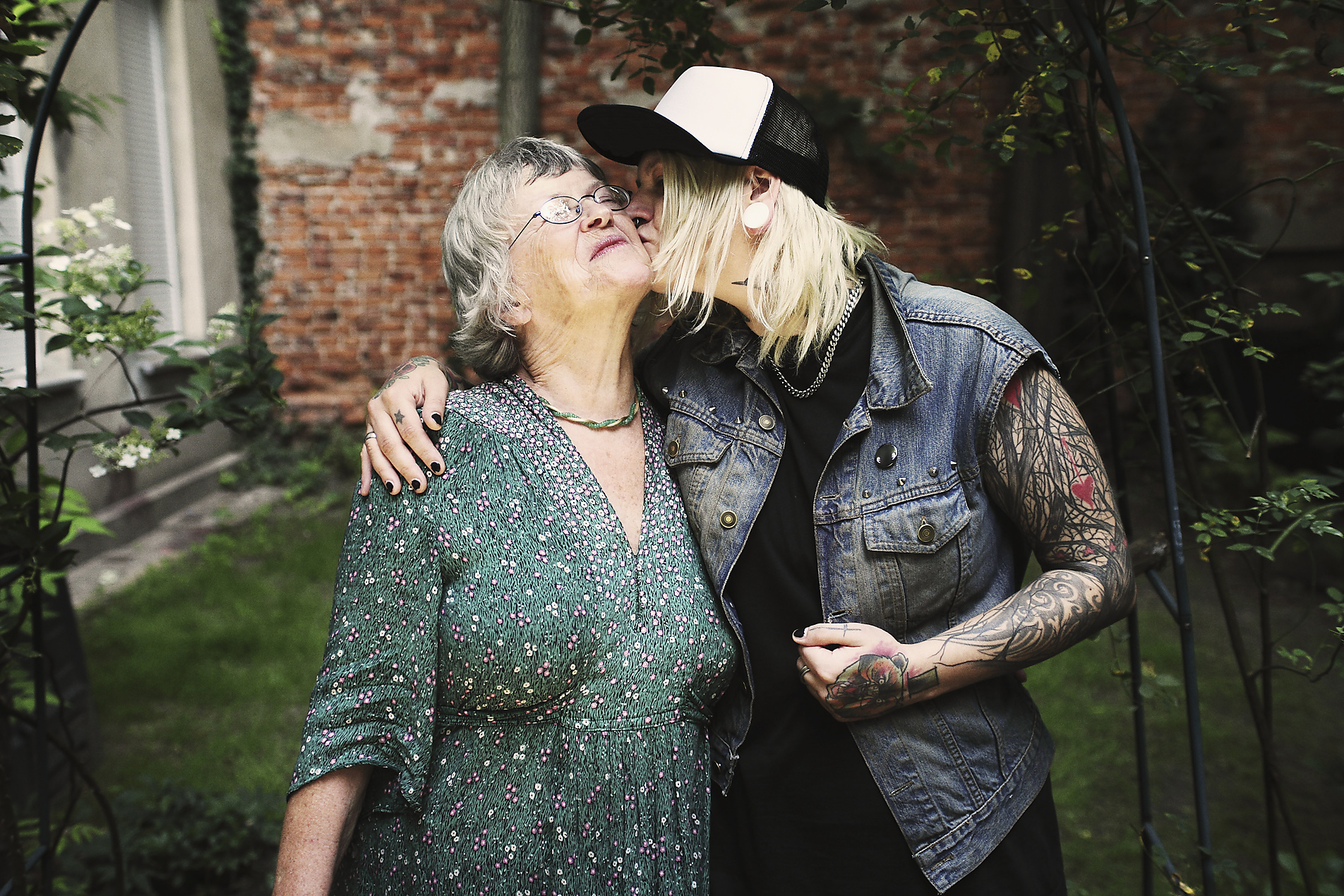 Stock Image, Royalty Free, Daughter kissing mother while standing in back yard