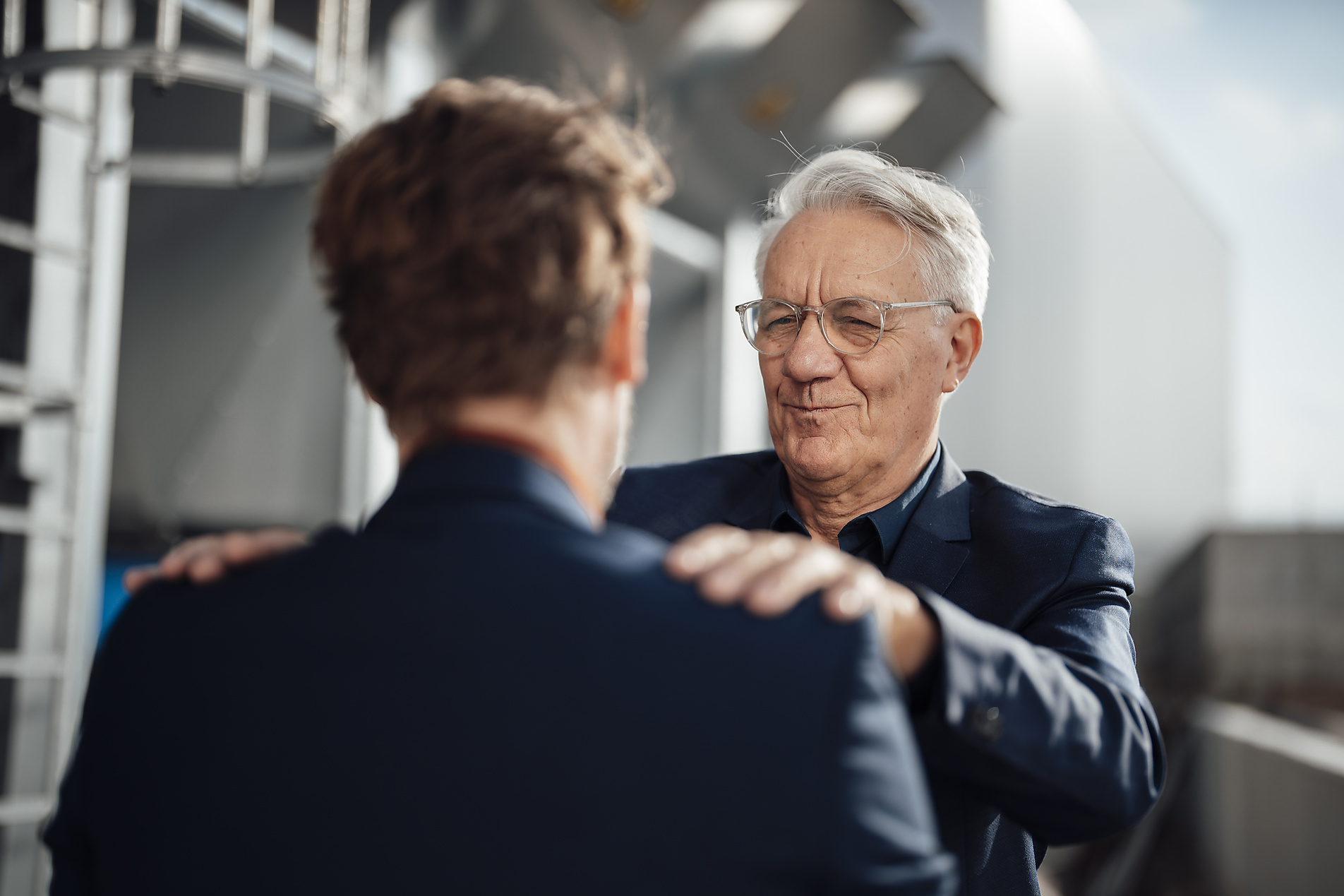 Stock Image, royalty free stock photo of Happy senior businessman supporting and embracing colleague
