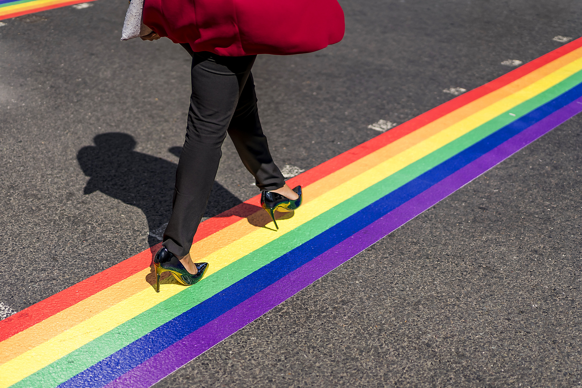 Stockphoto, Royalty Free Stock Image, Legs of businesswoman crossing the street on LGBT stripes, London, UK