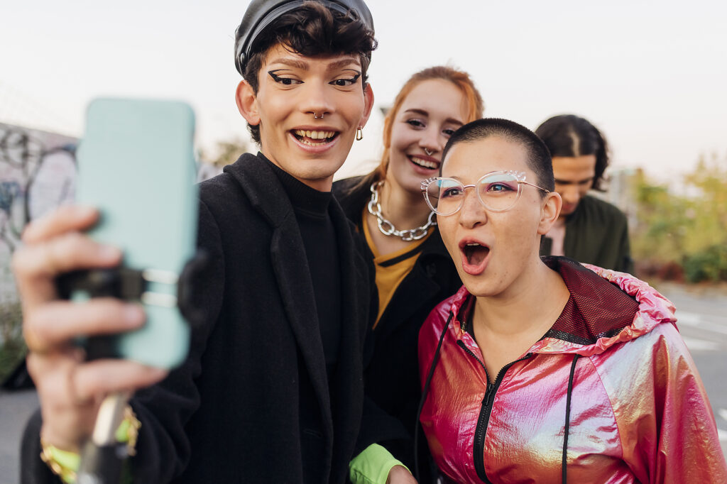 Smiling gay man taking selfie with friends through mobile phone Royalty free image Smiling gay man taking selfie with friends through mobile phone
Royalty free image