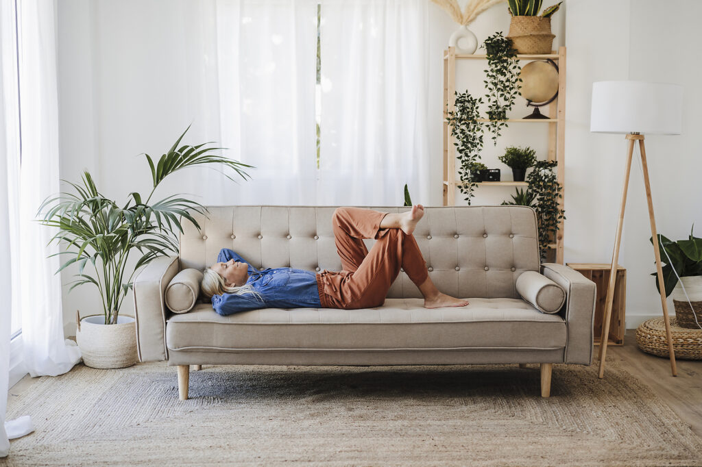 Woman relaxing on sofa in living room at home Stockphoto Woman relaxing on sofa in living room at home Stockphoto