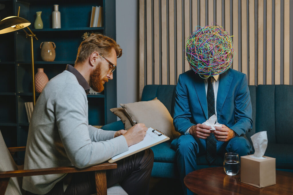 Psychotherapist writing problems of worried patient sitting on sofa Stockphoto Psychotherapist writing problems of worried patient sitting on sofa Stockphoto