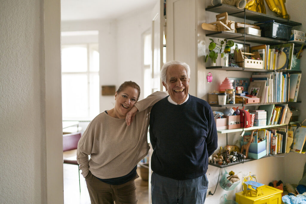 Portrait of happy senior couple standing in children's room
Royalty free image