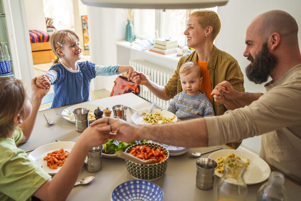 Family praying before lunch sitting at dining table
Royalty free image