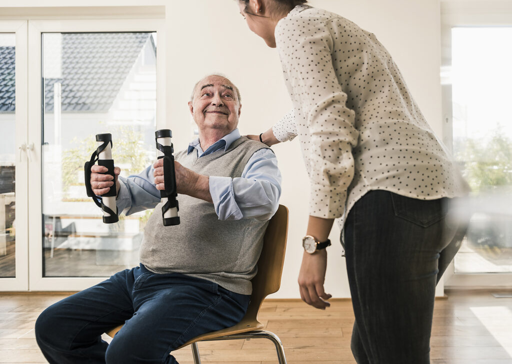 Young woman supporting senior man doing an arm exercise
Royalty free image