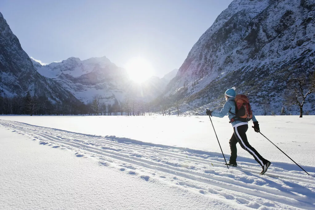 Germany, Bavaria, Senior woman doing cross-country skiing with karwendal mountains in background
Royalty free image