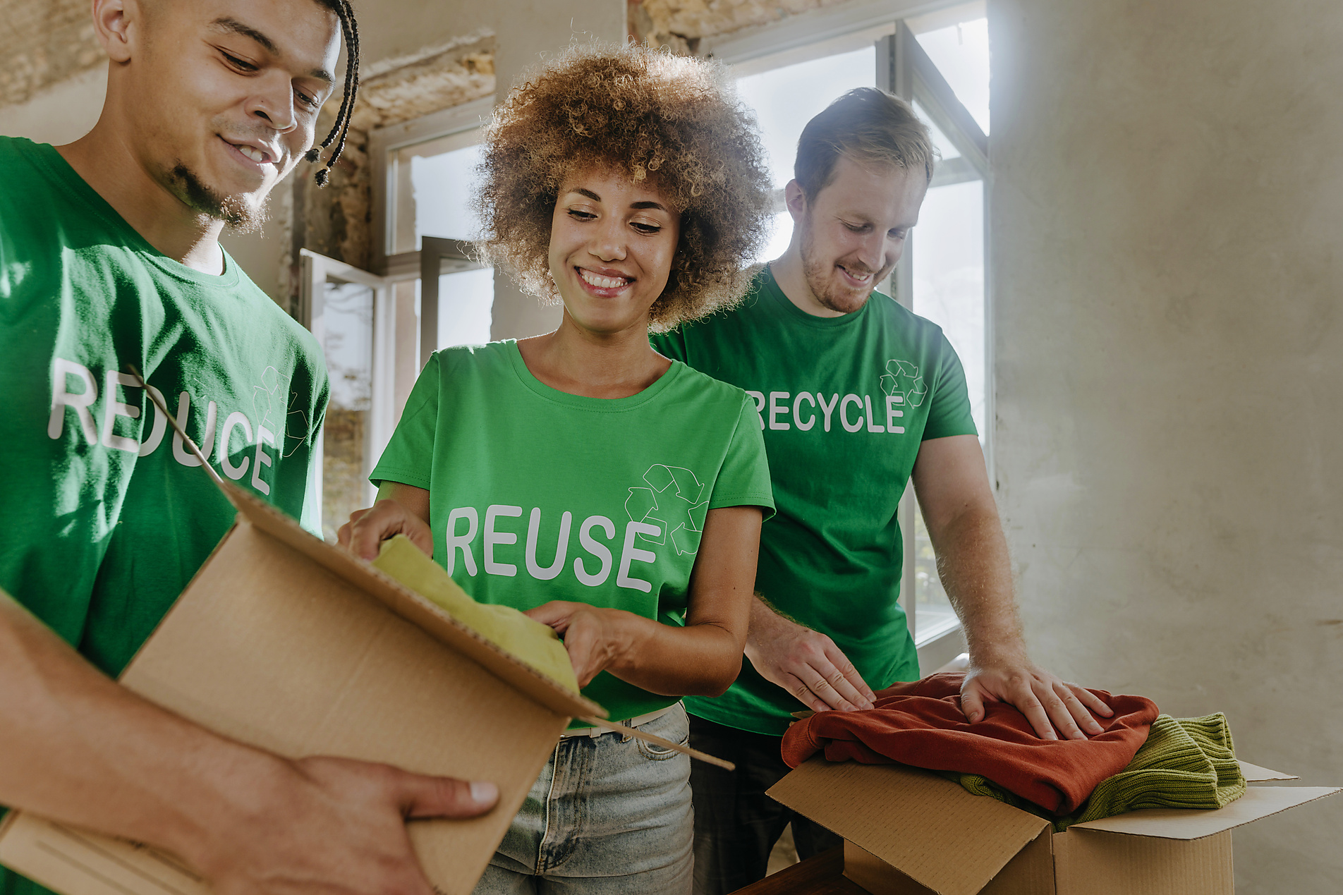 Smiling activists putting secondhand clothes in cardboard boxes
Royalty free image