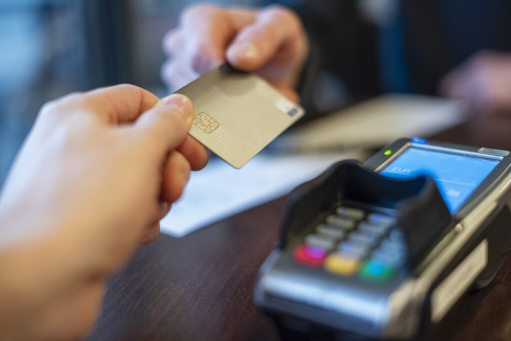 Hands exchanging a credit card for payment at a point of sale terminal
Royalty free image