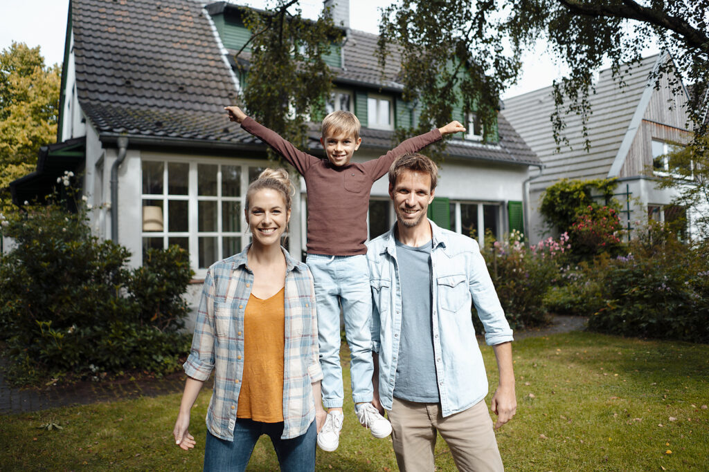 Happy mother and father lifting son with arms outstretched in backyard
Royalty free image