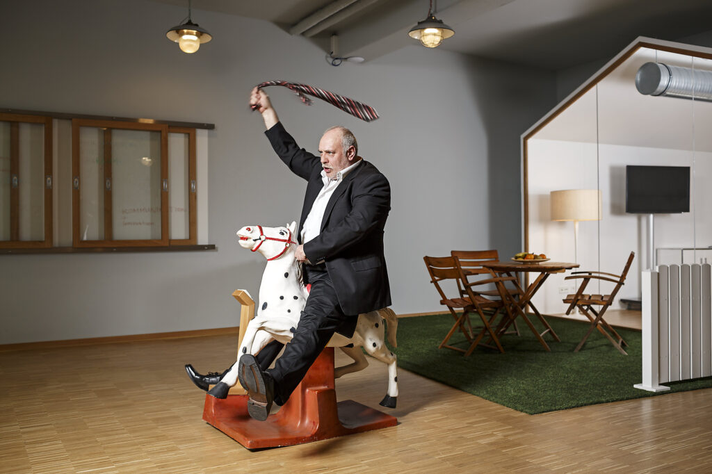 Businessman on rocking horse pretending to ride
Royalty-free image