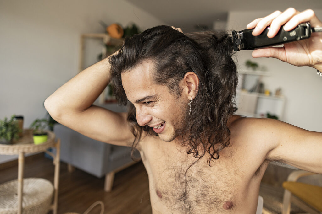 Happy man cutting hair with electric razor at home Royalty-free image Happy man cutting hair with electric razor at home
Royalty-free image