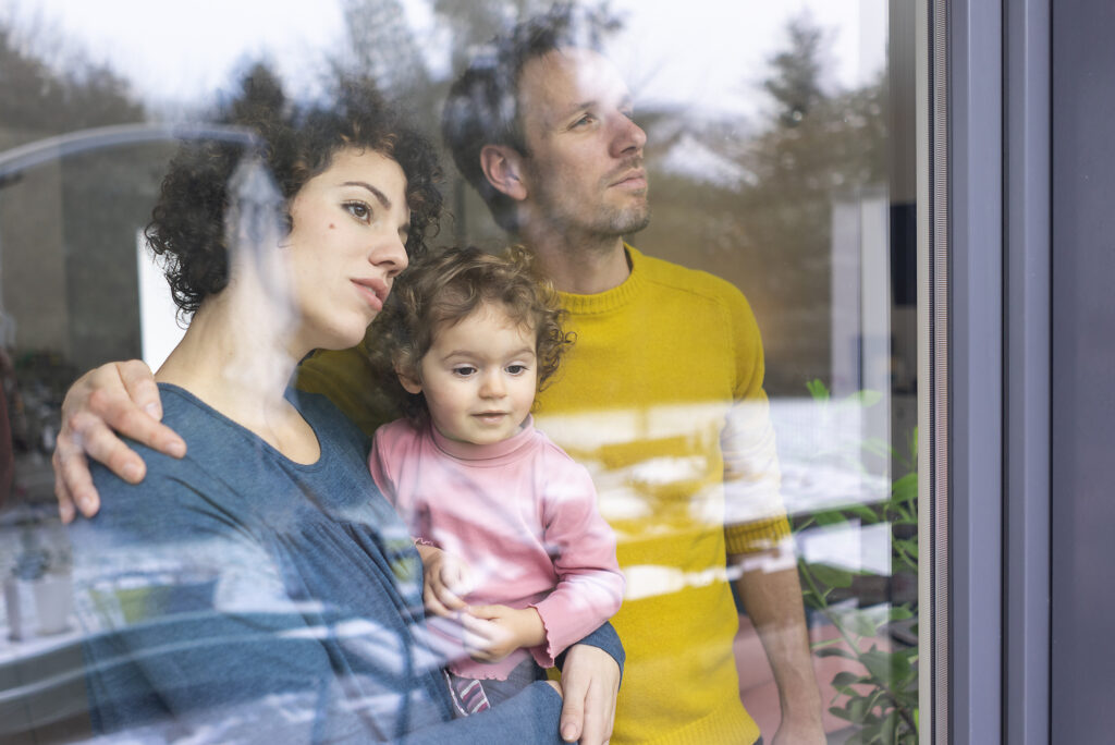 Happy family looking out of window, mother carrying daughter Royalty-free image Happy family looking out of window, mother carrying daughter
Royalty-free image