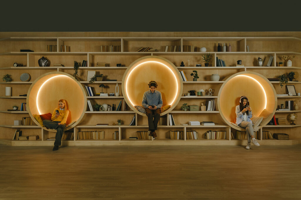 People relaxing with smartphones in cozy modern coworking library Royalty-free image People relaxing with smartphones in cozy modern coworking libraryRoyalty-free image