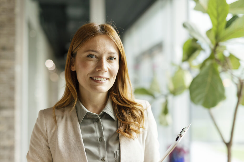 Confident businesswoman in office holding clipboard and smiling Royalty-free image Confident businesswoman in office holding clipboard and smiling
Royalty-free image